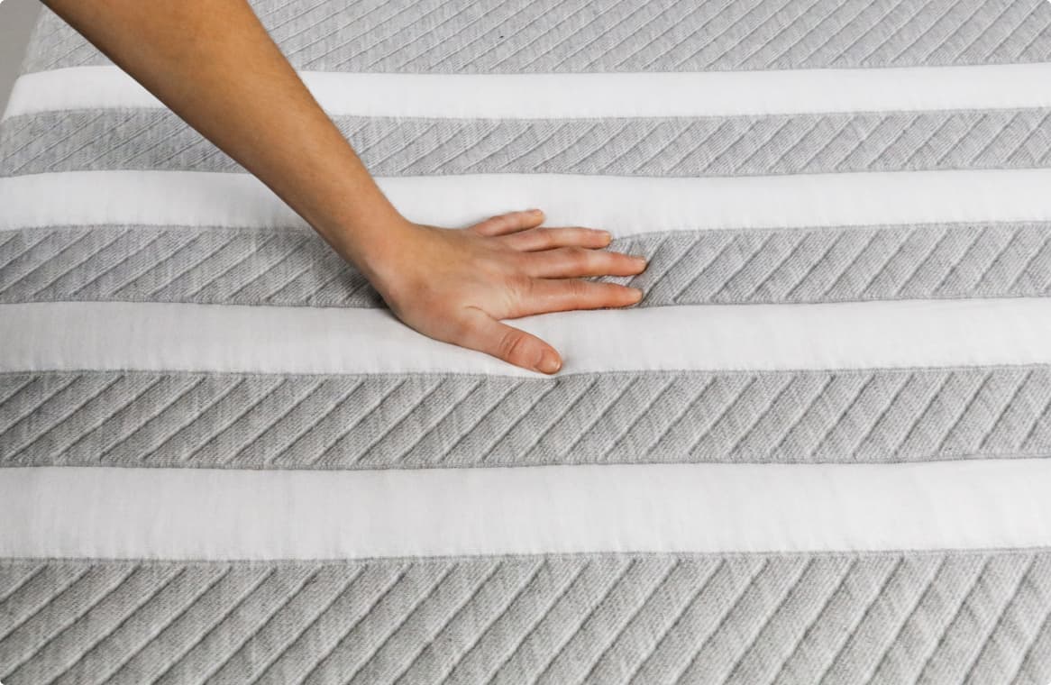 Hand on a mattress topper