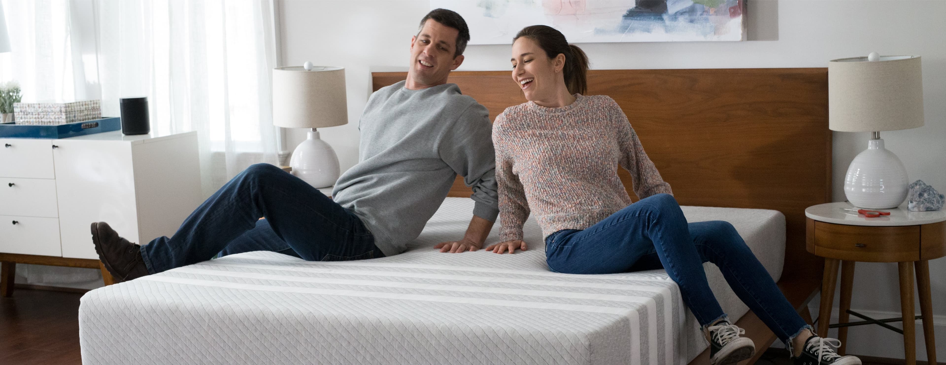 Couple sitting on a Leesa mattress